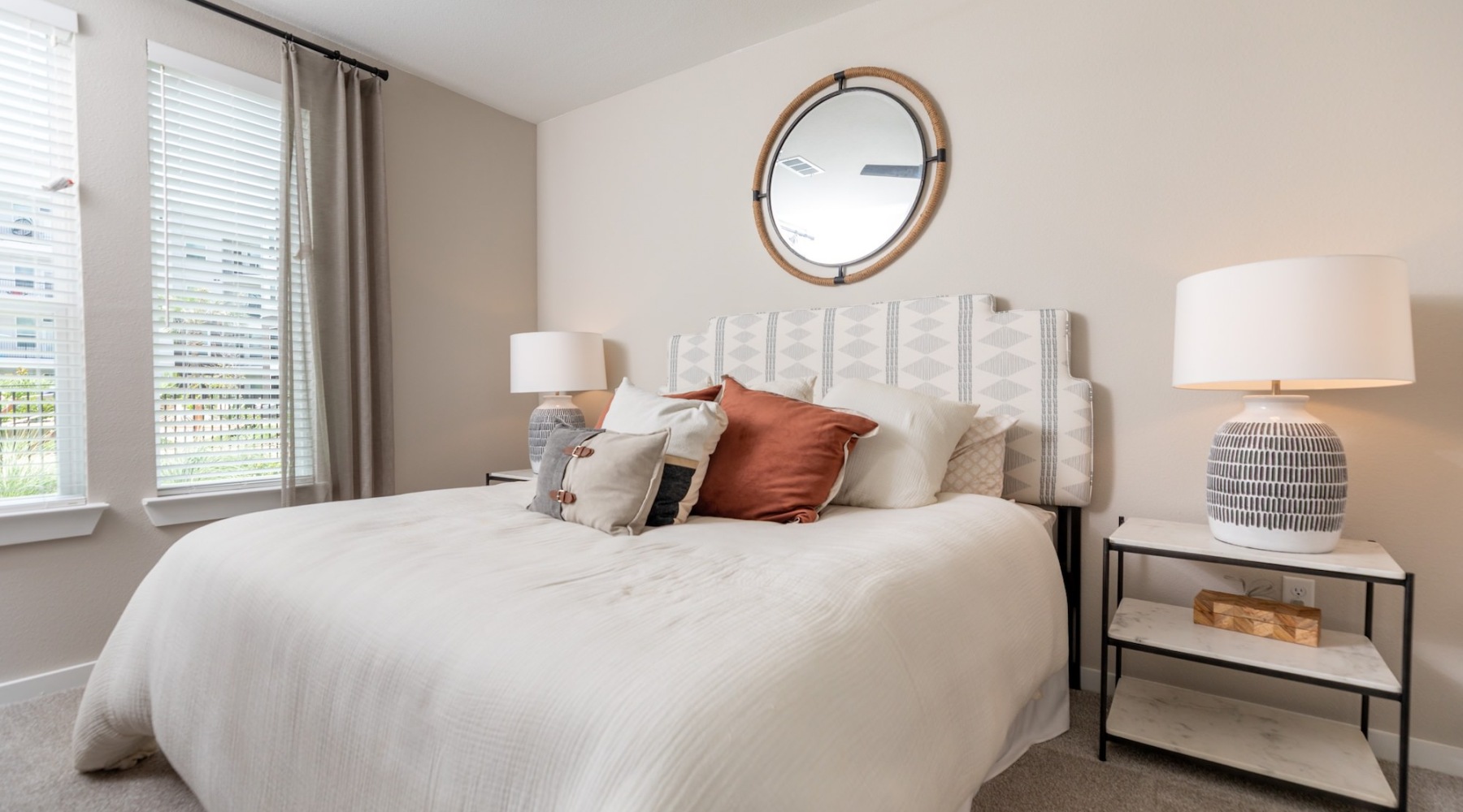 a bedroom with a large mirror
