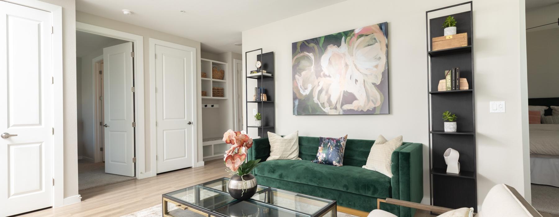 a living room with a green couch and a coffee table