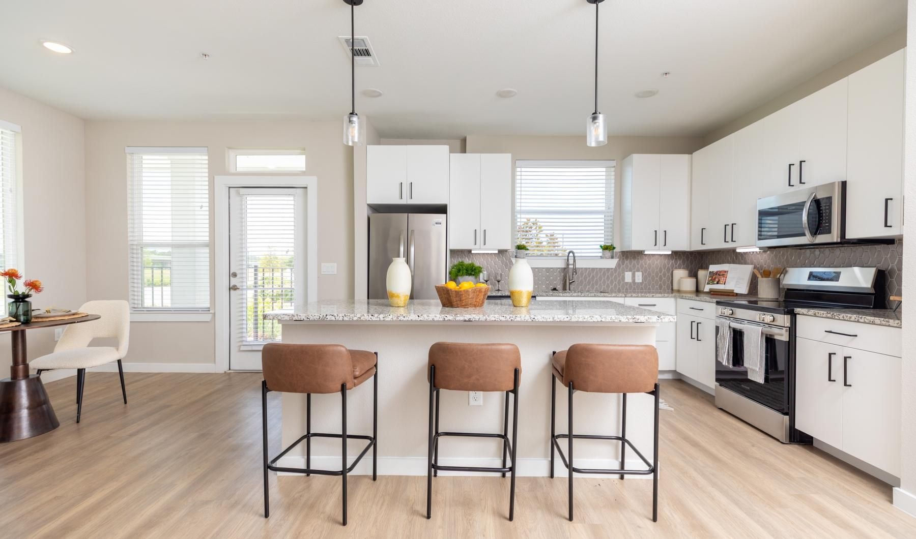 a kitchen with a table and chairs