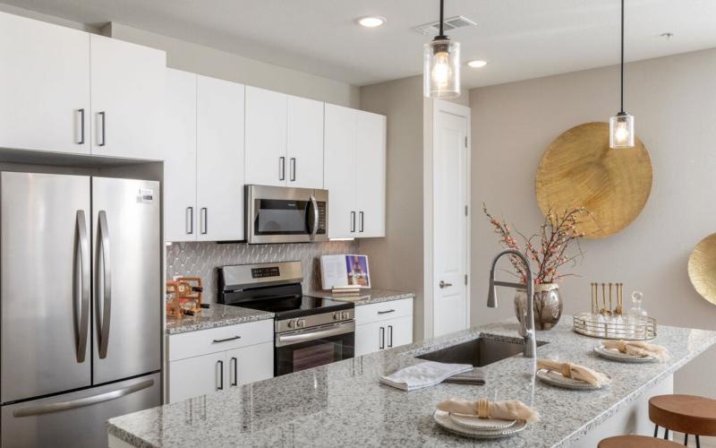 a kitchen with white cabinets